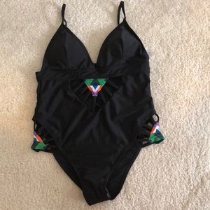 NWOT black swimsuit with subtle cut-outs.